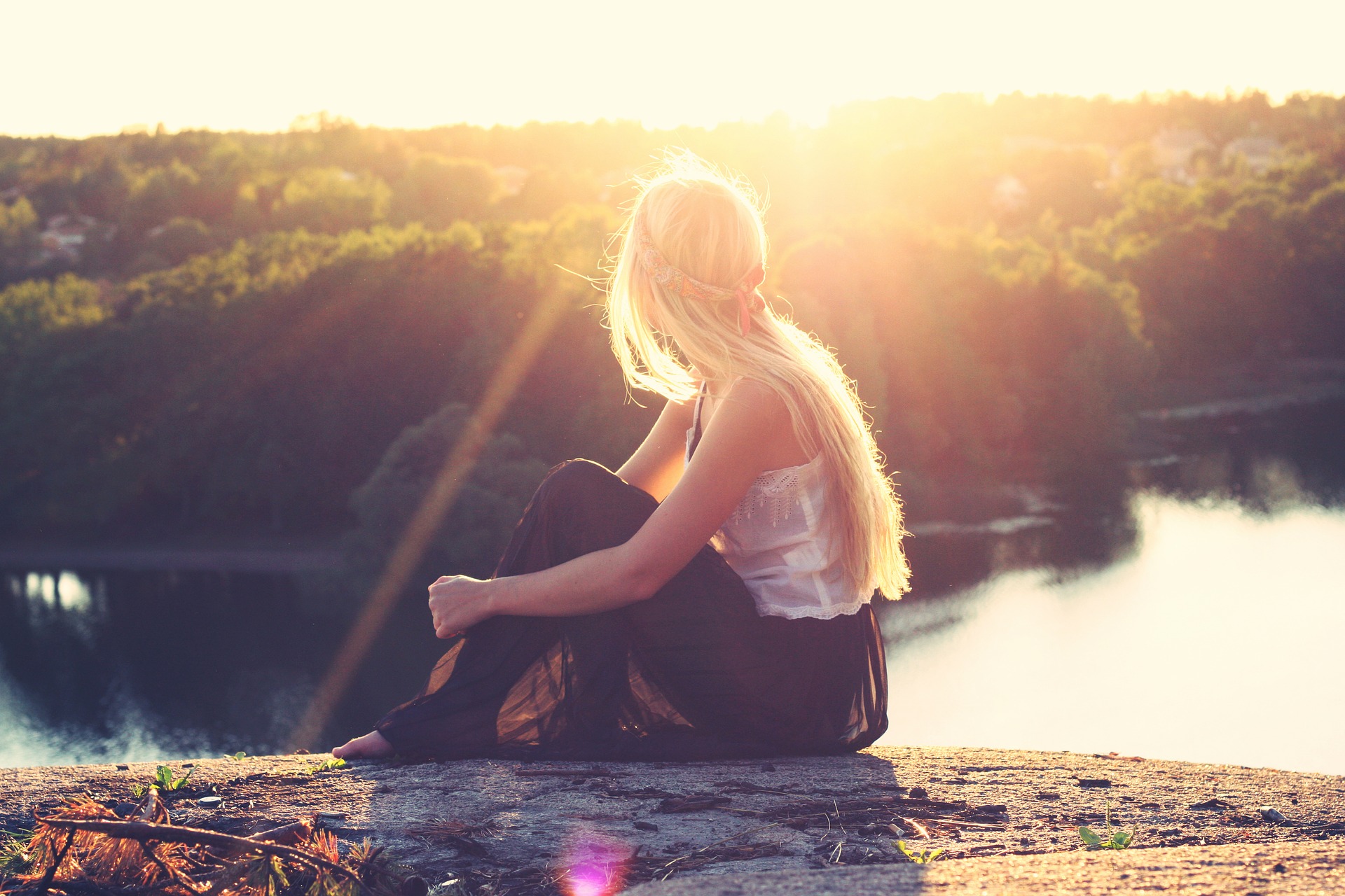 young woman watching sunset